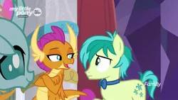 Size: 1280x720 | Tagged: safe, derpibooru import, screencap, ocellus, sandbar, smolder, changedling, changeling, dragon, earth pony, pony, she's all yak, amused, bowtie, claws, confused, crossed arms, curved horn, cutie mark, dragoness, fangs, female, folded wings, frown, horn, horns, lidded eyes, male, open mouth, smiling, smirk, smugder, teenaged dragon, teenager, trio, wings, young stallion