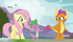 Size: 1508x882 | Tagged: safe, derpibooru import, screencap, fluttershy, smolder, spike, dragon, pegasus, pony, sweet and smoky, backpack, discovery family logo, dragoness, eyes closed, female, jazz hands, male, mare, outdoors, spread arms, trio, winged spike