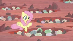 Size: 2100x1180 | Tagged: safe, derpibooru import, screencap, fluttershy, pegasus, pony, sweet and smoky, dragon egg, dragon lands, female, mare, nest, prone, solo