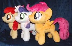 Size: 1280x824 | Tagged: safe, artist:peruserofpieces, derpibooru import, apple bloom, scootaloo, sweetie belle, earth pony, pegasus, pony, unicorn, accessory, bow, cutie mark crusaders, female, filly, happy, horn, irl, photo, plushie, profile, ribbon, side by side, smiling, toy, trio, wings