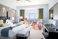 Size: 641x425 | Tagged: safe, derpibooru import, edit, editor:undeadponysoldier, apple bloom, rumble, scootaloo, spike, sweetie belle, pony, apple, balcony, bed, bedroom, bedroom eyes, book, ceiling fan, chair, couch, cutie mark crusaders, desk, dragons in real life, excited, food, happy, hotel room, irl, lamp, laying on bed, leaning back, looking up, ocean, on bed, one of these things is not like the others, pencil, photo, pillow, ponies in real life, relaxing, stupid sexy rumble