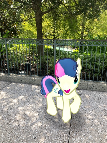 Size: 3024x4032 | Tagged: safe, derpibooru import, photographer:undeadponysoldier, bon bon, sweetie drops, earth pony, pony, augmented reality, bush, disney springs, disney world, downtown disney, female, gameloft, irl, looking at you, mare, open mouth, photo, ponies in real life, solo, tree