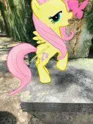 Size: 3024x4032 | Tagged: safe, derpibooru import, photographer:undeadponysoldier, fluttershy, butterfly, pegasus, pony, animal kingdom, augmented reality, disney world, female, florida, gameloft, irl, looking at you, mare, open mouth, orlando, photo, ponies in real life, pose, standing up