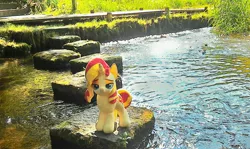 Size: 2048x1224 | Tagged: safe, artist:hihin1993, derpibooru import, sunset shimmer, pony, unicorn, female, irl, japan, lidded eyes, looking at you, mare, photo, plushie, smiling, smug, smugset shimmer, solo, stepping stones, water