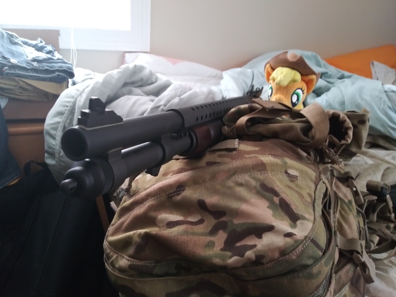 Size: 4160x3120 | Tagged: safe, derpibooru import, applejack, earth pony, pony, 4de, applejack's hat, backpack, bed, cowboy hat, female, gun, hat, irl, mare, mossberg 590a1, my little arsenal, photo, plushie, ponies with guns, shotgun, solo, weapon