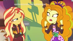 Size: 537x300 | Tagged: safe, derpibooru import, screencap, adagio dazzle, sunset shimmer, equestria girls, equestria girls series, sunset's backstage pass!, spoiler:eqg series (season 2), crossed arms, discovery kids, smugset shimmer, spanish, spiked headband