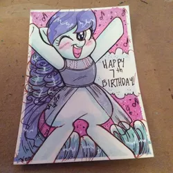 Size: 600x600 | Tagged: safe, artist:marybellamy, derpibooru import, coloratura, pony, birthday card, commission, eye shimmer, happy, looking at you, music notes, one eye closed, rara, san diego comic con, smiling, standing, standing up, traditional art, wink