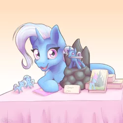 Size: 2000x2000 | Tagged: safe, artist:ohemo, derpibooru import, trixie, pony, unicorn, atg 2019, book, convention, cute, figurine, looking at you, mouth hold, narcissism, newbie artist training grounds, open mouth, smiling, sword, table, weapon