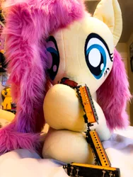 Size: 3024x4032 | Tagged: safe, artist:natureshy, derpibooru import, fluttershy, pony, cute, destruction, female, giant pony, giantess, life size, macro, nom, playing, plushie, shyabetes, silly, silly pony, train