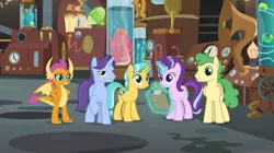 Size: 1087x607 | Tagged: safe, derpibooru import, screencap, citrine spark, fire quacker, huckleberry, november rain, smolder, squirk, starlight glimmer, dragon, octopus, pegasus, pony, unicorn, a horse shoe-in, claws, clipboard, doctor whooves' lab, dragoness, female, flameless fireworks, friendship student, glowing horn, horn, horns, laboratory, magic, magic aura, mare, pencil, raised eyebrow, raised hoof, specimens, spread wings, students, teenager, telekinesis, wings, young