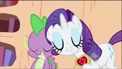 Size: 1280x720 | Tagged: safe, derpibooru import, screencap, rarity, spike, dragon, pony, unicorn, secret of my excess, bookshelf, cute, cutie mark, eyes closed, eyeshadow, female, fire ruby, gem, golden oaks library, hub logo, jewelry, makeup, male, mare, necklace, nuzzling, ruby, shipping fuel, spikelove