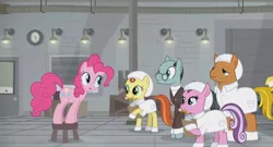 Size: 1366x738 | Tagged: safe, derpibooru import, screencap, pinkie pie, sans smirk, pony, the last laugh, clipboard, clothes, crate, factory, gag factory, glasses, lights, pencil, stool, suit, white coat, worker