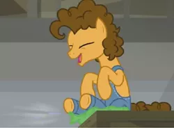 Size: 1048x772 | Tagged: safe, derpibooru import, screencap, cheese sandwich, pony, the last laugh, clothes, dungarees, factory, gag factory, overalls, sitting, solo, whoopie cushion