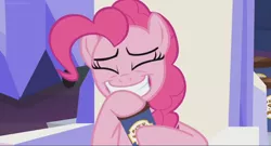 Size: 1366x740 | Tagged: safe, derpibooru import, screencap, pinkie pie, earth pony, pony, the last laugh, eyes closed, female, grin, mare, peanut brittle, sitting, smiling, solo, throne