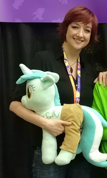 Size: 1100x1820 | Tagged: safe, artist:hoppip, derpibooru import, lyra heartstrings, human, pony, unicorn, bronycon, bronycon 2019, 2019, autograph, betrayal, blessed image, clothes, cropped, cursed image, everything is ruined, female, irl, irl human, lauren faust, lyra plushie, mare, not salmon, pants, photo, plothole plush lyra, plushie, signature, wat, we are going to hell