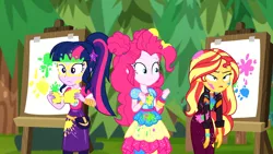 Size: 1916x1080 | Tagged: safe, derpibooru import, screencap, pinkie pie, sci-twi, sunset shimmer, twilight sparkle, equestria girls, equestria girls series, sunset's backstage pass!, spoiler:eqg series (season 2), canvas, easel, female, geode of sugar bombs, geode of telekinesis, magical geodes, messy, messy hair, outdoors, paint, painting, ponytail, sunset shimmer is not amused, trio, trio female, unamused