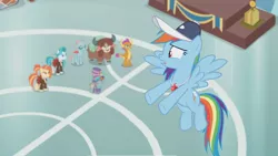 Size: 1362x766 | Tagged: 2 4 6 greaaat, blurry, cap, derpibooru import, face paint, flying, gym, hat, lighthoof, ocellus, podium, rainbow dash, safe, screencap, shimmy shake, smolder, snips, top hat, unsure, whistle, yona