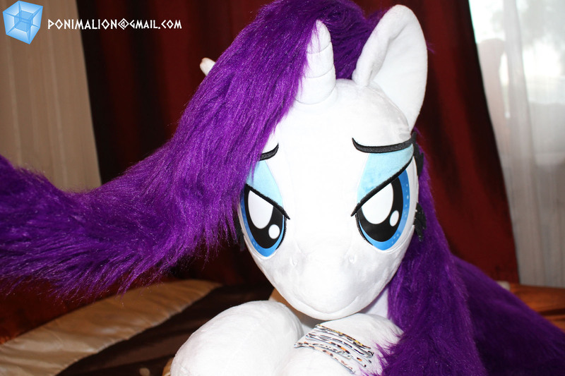 Size: 1601x1067 | Tagged: safe, artist:ponimalion, derpibooru import, rarity, pony, unicorn, bed, bedroom, bedroom eyes, female, horn, irl, looking at you, photo, plushie, solo