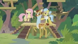 Size: 1600x900 | Tagged: safe, derpibooru import, screencap, clementine, doctor fauna, fluttershy, earth pony, giraffe, pegasus, pony, she talks to angel, bush, cloven hooves, female, mare, neck brace, platform, sweet feather sanctuary, tree