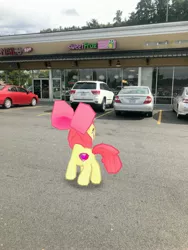 Size: 3024x4032 | Tagged: safe, derpibooru import, photographer:undeadponysoldier, apple bloom, earth pony, pony, augmented reality, building, car, cutie mark, female, filly, gameloft, irl, parking lot, photo, ponies in real life, solo, sweet frog, the cmc's cutie marks