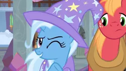 Size: 1600x900 | Tagged: safe, derpibooru import, screencap, big macintosh, trixie, earth pony, pony, unicorn, a horse shoe-in, cape, clothes, column, female, hat, male, mare, one eye closed, stallion, trixie's cape, trixie's hat, wink