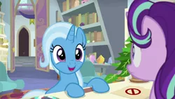 Size: 1920x1080 | Tagged: safe, derpibooru import, screencap, phyllis, starlight glimmer, trixie, pony, unicorn, a horse shoe-in, bookshelf, cute, diatrixes, duo, excited, eyes closed, female, folder, frown, happy, hooves on the table, mare, open mouth, philodendron, school of friendship, smiling, starlight's office, too cute