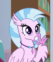 Size: 676x780 | Tagged: a horse shoe-in, bookshelf, classical hippogriff, claws, cropped, cute, derpibooru import, diastreamies, female, folded wings, grin, hippogriff, jewelry, looking at you, necklace, pearl necklace, safe, screencap, silverstream, sitting, smiling, solo, squee, talons, teenager, waving, wings