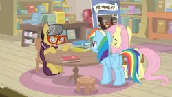 Size: 1600x900 | Tagged: safe, derpibooru import, screencap, a.k. yearling, fluttershy, rainbow dash, pegasus, pony, daring doubt, bag, book, bookshelf, cape, clothes, couch, female, glasses, mare, pen, sad, saddle bag, shelf, sign, sitting, stool, table