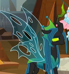 Size: 514x550 | Tagged: annoyed, changeling, changeling queen, cozy glow, cropped, crown, derpibooru import, evil lair, female, filly, former queen chrysalis, grogar's lair, horn, jewelry, lair, queen chrysalis, queen chrysalis is not amused, regalia, safe, screencap, solo focus, spread wings, the ending of the end, ultimate chrysalis, unamused, wings