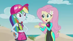 Size: 1920x1080 | Tagged: safe, derpibooru import, screencap, fluttershy, rainbow dash, aww... baby turtles, equestria girls, equestria girls series, baseball cap, beach, beach babe, belly button, cap, clothes, cute, dashabetes, duo, duo female, female, geode of fauna, geode of super speed, hands on hip, hat, magical geodes, midriff, open mouth, shorts, shyabetes, smiling, wetsuit