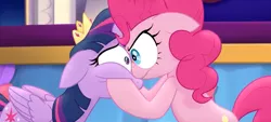 Size: 1258x568 | Tagged: safe, derpibooru import, screencap, pinkie pie, twilight sparkle, twilight sparkle (alicorn), alicorn, earth pony, pony, my little pony: the movie, angry, duo, eye bulging, eye contact, female, hooves on cheeks, looking at each other, mare, serious