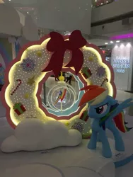 Size: 720x960 | Tagged: safe, derpibooru import, photographer:henrychan, rainbow dash, pegasus, pony, candy, candy cane, food, hong kong, irl, photo, present, solo, statue