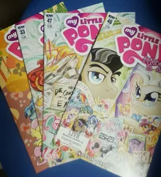 Size: 1836x2019 | Tagged: safe, derpibooru import, idw, filthy rich, fluttershy, mayor mare, rainbow dash, vinyl scratch, earth pony, pegasus, pony, unicorn, spoiler:comic, spoiler:comic33, spoiler:comic46, spoiler:comic47, comic, female, glasses, glowing horn, horn, irl, magic, male, mare, microphone, photo, sign, stallion, sunglasses, telekinesis