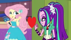Size: 1100x618 | Tagged: safe, derpibooru import, aria blaze, fluttershy, best in show: the victory lap, equestria girls, equestria girls series, rainbow rocks, spoiler:eqg series (season 2), ariashy, cute, female, flutterblaze, heart, lesbian, microphone, playing with hair, shipping, shipping domino, wrong aspect ratio