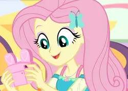 Size: 1505x1080 | Tagged: safe, derpibooru import, screencap, fluttershy, equestria girls, equestria girls series, holidays unwrapped, spoiler:eqg series (season 2), camera, canterlot mall, chair, clothes, cropped, cute, dashing through the mall, dress, female, female focus, geode of fauna, hairclip, happy, jewelry, magical geodes, mall, necklace, present, shyabetes, sitting, smiling, solo focus