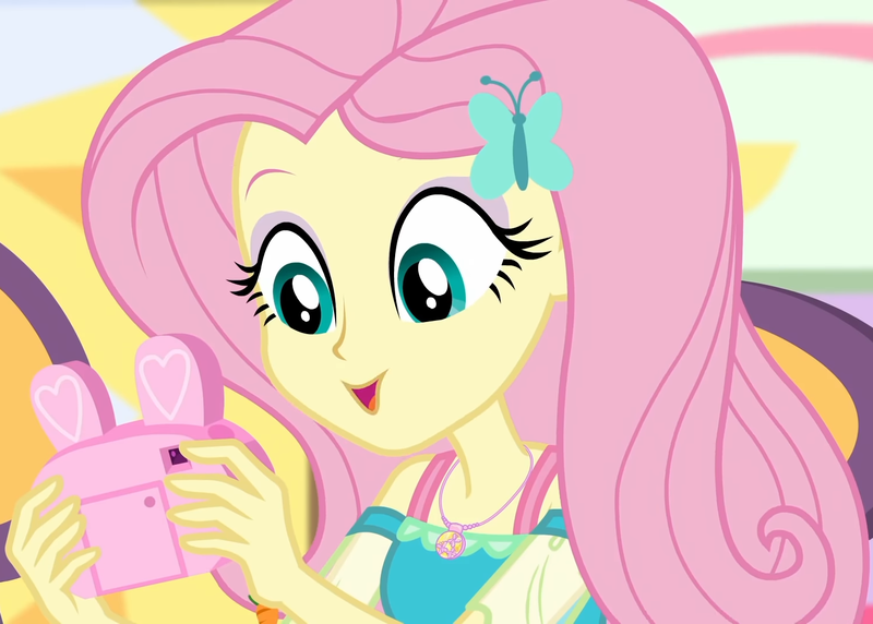 Size: 1511x1080 | Tagged: safe, derpibooru import, screencap, fluttershy, equestria girls, equestria girls series, holidays unwrapped, spoiler:eqg series (season 2), camera, canterlot mall, chair, clothes, cropped, cute, dashing through the mall, dress, female, geode of fauna, hairclip, happy, jewelry, looking down, magical geodes, mall, necklace, present, shyabetes, sitting, solo