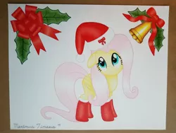 Size: 4032x3024 | Tagged: safe, artist:maximustimaeus, derpibooru import, fluttershy, pegasus, pony, bell, bow, christmas, clothes, colored pencil drawing, costume, female, hat, holiday, holly, mare, ribbon, santa costume, santa hat, simple background, smiling, socks, solo, traditional art, white background