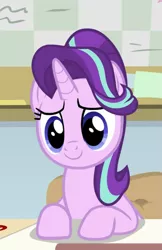 Size: 609x937 | Tagged: safe, derpibooru import, screencap, starlight glimmer, pony, unicorn, a horse shoe-in, cropped, cute, desk, female, glimmerbetes, mare, smiling, solo