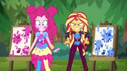 Size: 1920x1080 | Tagged: safe, derpibooru import, screencap, pinkie pie, sunset shimmer, equestria girls, equestria girls series, sunset's backstage pass!, spoiler:eqg series (season 2), angry, clothes, cute, diapinkes, duo, duo female, easel, female, geode of empathy, geode of sugar bombs, happy, magical geodes, messy, music festival outfit, outdoors, paint, pantyhose, smiling, sunset shimmer is not amused, unamused, varying degrees of amusement