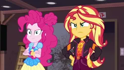 Size: 1920x1080 | Tagged: safe, derpibooru import, screencap, pinkie pie, sunset shimmer, equestria girls, equestria girls series, sunset's backstage pass!, spoiler:eqg series (season 2), crossed arms, duo, duo female, female, geode of empathy, geode of sugar bombs, hands on hip, magical geodes, music festival outfit, sunset shimmer is not amused, unamused