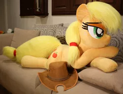 Size: 1024x778 | Tagged: safe, artist:ponimalion, derpibooru import, applejack, earth pony, pony, bed, couch, female, hat, lidded eyes, life size, mare, plushie, prone