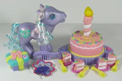 Size: 902x600 | Tagged: safe, derpibooru import, photographer:breyer600, razzaroo, pony, g3, birthday cake, box, cake, candle, charm bracelet, comb, cute, food, fork, photo, present, toy