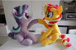 Size: 540x359 | Tagged: safe, artist:nekokevin, derpibooru import, starlight glimmer, sunset shimmer, pony, unicorn, series:nekokevin's glimmy, animated, cute, duo, female, gif, glimmerbetes, hoofbump, irl, looking at each other, mare, open mouth, photo, playing, plushie, raised hoof, shimmerbetes, sitting, smiling, stop motion