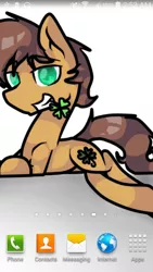 Size: 576x1024 | Tagged: safe, artist:mcwolfity, deleted from derpibooru, derpibooru import, oc, oc:charmed clover, unofficial characters only, earth pony, pony, clover, earth pony oc, flower, flower in mouth, four leaf clover, grin, male, mouth hold, phone screen, prone, smiling, stallion