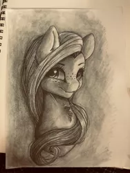 Size: 3024x4032 | Tagged: safe, artist:miokomata, derpibooru import, fluttershy, pegasus, pony, bust, chest fluff, fangs, female, freckles, freckleshy, grayscale, irl, looking at you, mare, monochrome, photo, sketch, sketchbook, traditional art