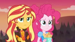 Size: 1920x1080 | Tagged: safe, derpibooru import, screencap, pinkie pie, sunset shimmer, equestria girls, equestria girls series, sunset's backstage pass!, spoiler:eqg series (season 2), arms folded, churros, clothes, duo, duo female, female, food, jacket, music festival outfit, outdoors, raised eyebrow