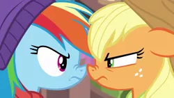 Size: 1280x720 | Tagged: safe, derpibooru import, screencap, applejack, rainbow dash, earth pony, pegasus, pony, triple pony dare ya, applejack is not amused, applejack's hat, boop, competitive, cowboy hat, determined, duo, female, freckles, frown, glare, green eyes, hat, looking at each other, magenta eyes, mare, multicolored mane, narrowed eyes, nose wrinkle, noseboop, rainbow dash is not amused, rivalry, stetson, unamused, winter cap