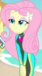 Size: 454x815 | Tagged: safe, derpibooru import, screencap, applejack, fluttershy, butterfly, equestria girls, equestria girls series, forgotten friendship, beach, bodysuit, clothes, cropped, cute, female, geode of fauna, hairclip, hands together, jewelry, lidded eyes, long sleeves, magical geodes, necklace, ocean, sand, shyabetes, sky, smiling, swimsuit, wetsuit