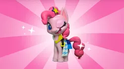 Size: 2048x1143 | Tagged: safe, derpibooru import, screencap, pinkie pie, earth pony, pony, fashion failure, my little pony: pony life, my little pony: stop motion short, clothes, dress, female, mare, one eye closed, open mouth, smiling, solo, sparkles, stop motion, winking at you