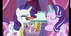 Size: 828x424 | Tagged: safe, derpibooru import, screencap, rarity, spike, starlight glimmer, dragon, pony, unicorn, a-dressing memories, spoiler:a-dressing memories, spoiler:mlp friendship is forever, 9now, book, eyes closed, female, glasses, levitation, magic, male, mare, measuring tape, nine network, rarity's glasses, telekinesis, unamused